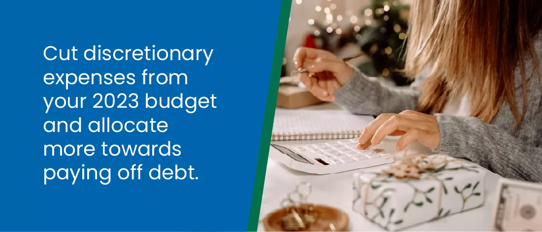 Cut discretionary expenses from your 2023 budget and allocate more towards paying off debt - close up of a woman with a notebook and calculator
